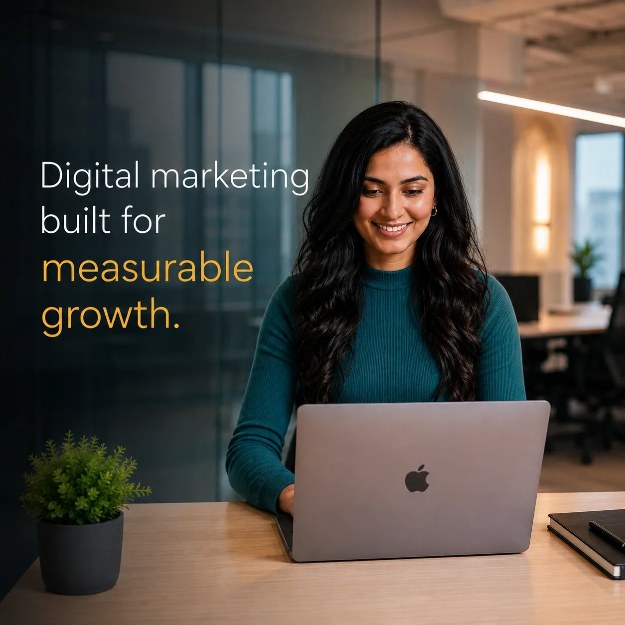 Digital marketing professional working on a laptop in an office